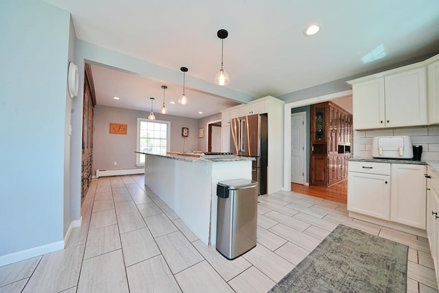 428 Main St, Orono, ME 04473 - kitchen featuring a baseboard heating unit, stainless steel appliances, a kitchen island, light stone counters, and recessed lighting