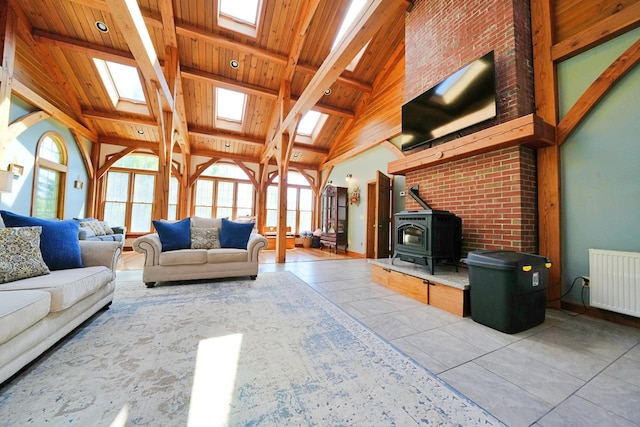 428 Main St, Orono, ME 04473 - living area with a skylight, radiator, wood ceiling with exposed beams, a wood stove, and high vaulted ceiling