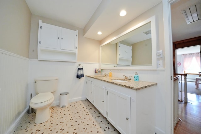428 Main St, Orono, ME 04473 - bathroom featuring a wainscoted wall, vanity, toilet, and recessed lighting