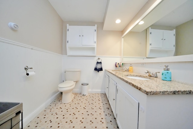 428 Main St, Orono, ME 04473 - bathroom with wainscoting, vanity, tile patterned floors, toilet, and recessed lighting