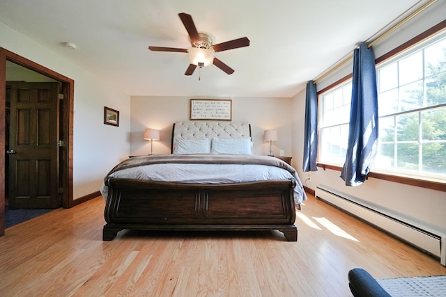 428 Main St, Orono, ME 04473 - bedroom featuring baseboard heating, light wood-type flooring, baseboards, and ceiling fan