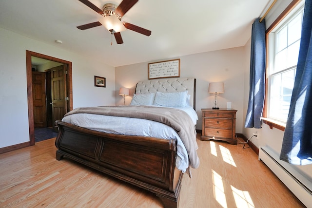 428 Main St, Orono, ME 04473 - bedroom with a baseboard radiator, multiple windows, light wood finished floors, and ceiling fan