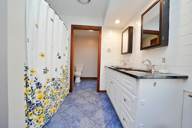 428 Main St, Orono, ME 04473 - full bath with toilet, double vanity, recessed lighting, baseboards, and stone finish floors