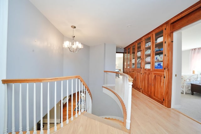 428 Main St, Orono, ME 04473 - stairs with wood finished floors and a chandelier