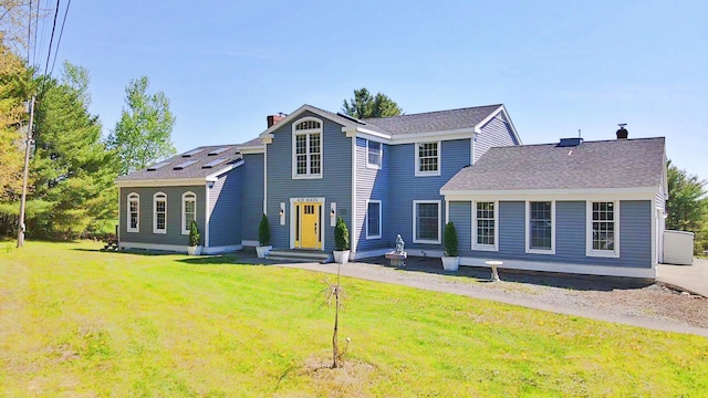 428 Main St, Orono, ME 04473 - view of front of house with a chimney, a front yard, and roof with shingles
