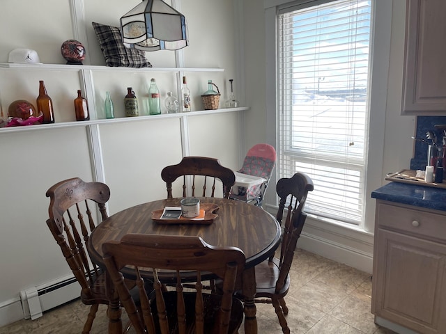 dining room featuring baseboard heating, a wealth of natural light, and light tile floors