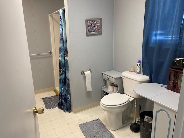 bathroom with toilet and tile flooring