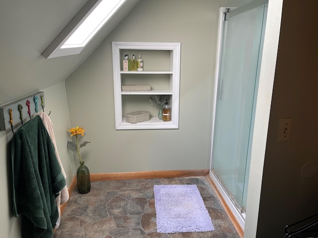 bathroom featuring vaulted ceiling with skylight, tile flooring, and walk in shower