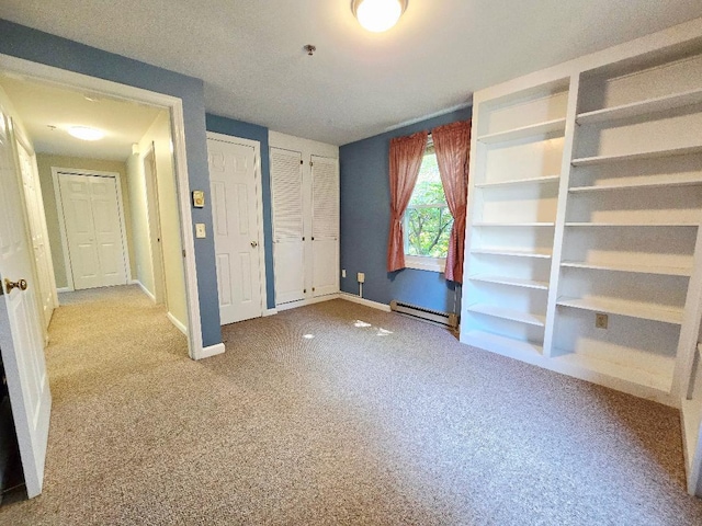 40 Willow Grove Rd, Brunswick, ME 04011 - unfurnished bedroom with a baseboard heating unit, multiple closets, and carpet floors