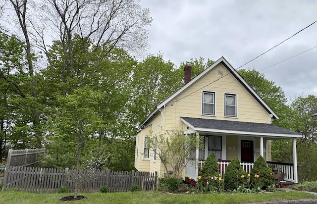24 Glidden St, Waldoboro, ME 04572 - view of front of home with a porch, a chimney, and roof with shingles
