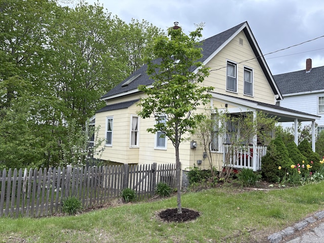 24 Glidden St, Waldoboro, ME 04572 - view of front of home with a chimney, roof with shingles, and covered porch