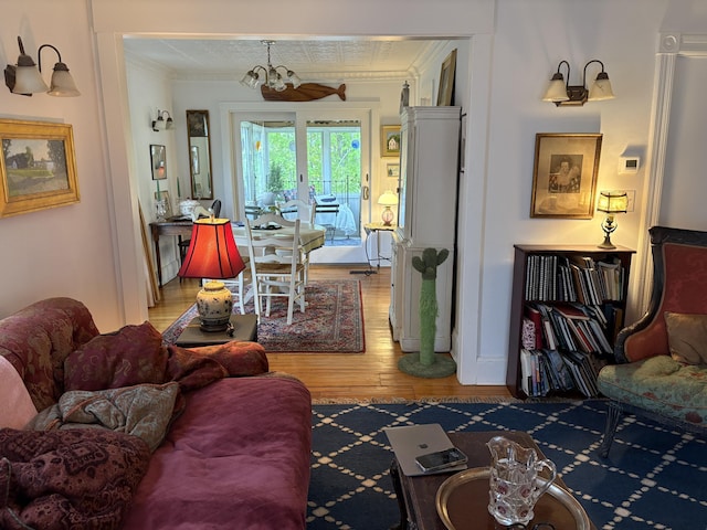 24 Glidden St, Waldoboro, ME 04572 - living room featuring light wood-style flooring, crown molding, and a chandelier