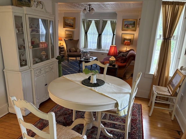 24 Glidden St, Waldoboro, ME 04572 - dining space featuring light wood-style flooring, healthy amount of natural light, baseboards, and crown molding