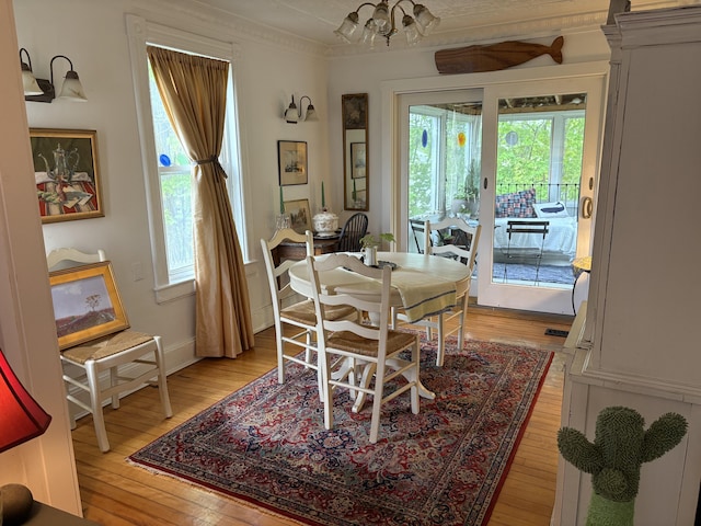 24 Glidden St, Waldoboro, ME 04572 - dining space featuring light wood-type flooring, healthy amount of natural light, crown molding, a chandelier, and baseboards