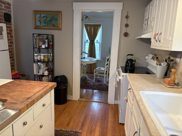 24 Glidden St, Waldoboro, ME 04572 - kitchen featuring white appliances, butcher block countertops, light wood-type flooring, a sink, and under cabinet range hood