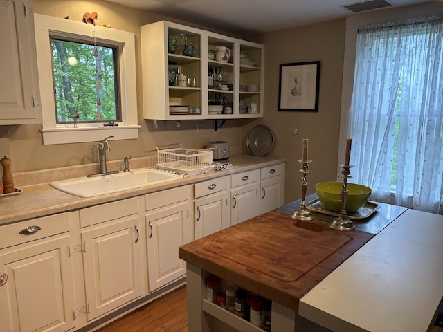 24 Glidden St, Waldoboro, ME 04572 - kitchen featuring open shelves, a sink, and white cabinetry