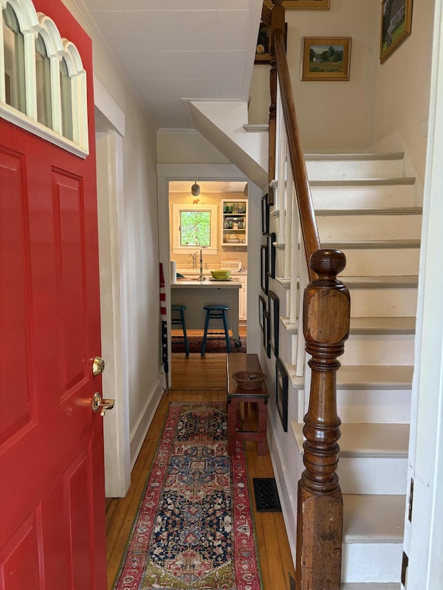 24 Glidden St, Waldoboro, ME 04572 - foyer entrance with hardwood / wood-style flooring, stairs, and crown molding