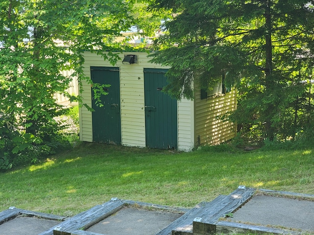 view of outdoor structure featuring a lawn