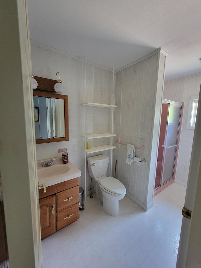 bathroom with crown molding, toilet, vanity, and walk in shower