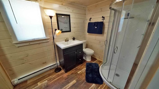 bathroom with an enclosed shower, wood walls, a baseboard radiator, vanity, and hardwood / wood-style flooring