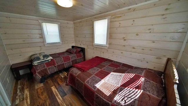 bedroom featuring dark hardwood / wood-style flooring, wooden walls, and wood ceiling