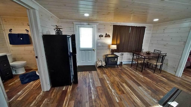 interior space featuring dark hardwood / wood-style flooring, wooden walls, and wood ceiling