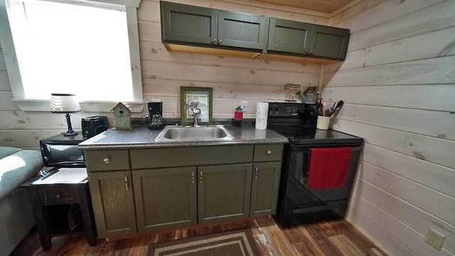 kitchen with wooden walls, dark hardwood / wood-style floors, sink, and black range with electric cooktop