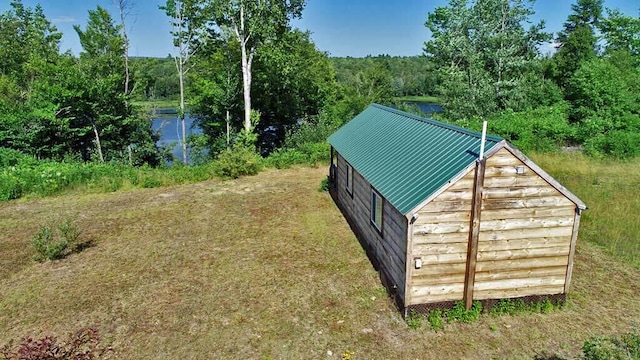 view of outdoor structure featuring a yard and a water view