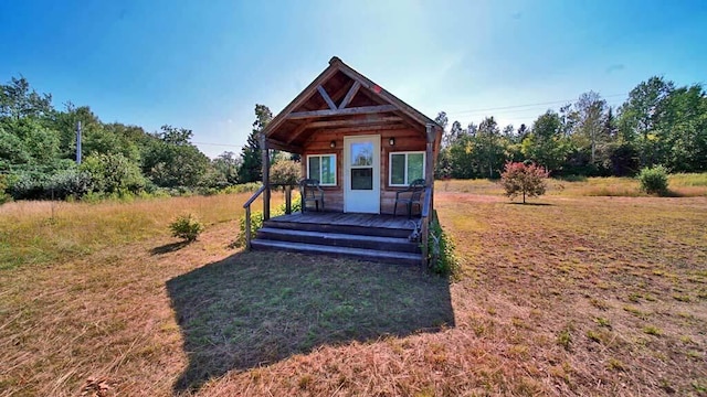 exterior space featuring a deck and a front lawn