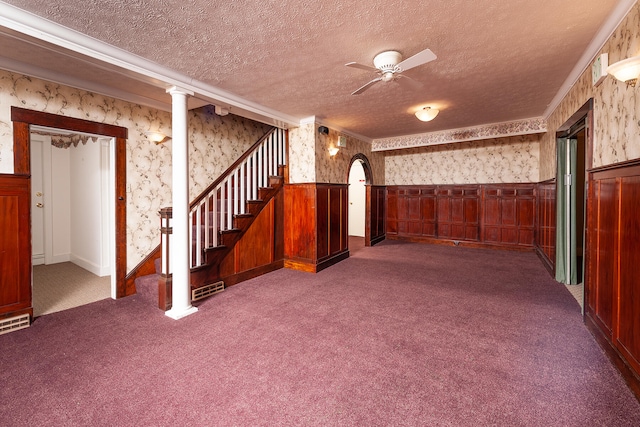 basement with ceiling fan, dark colored carpet, and a textured ceiling