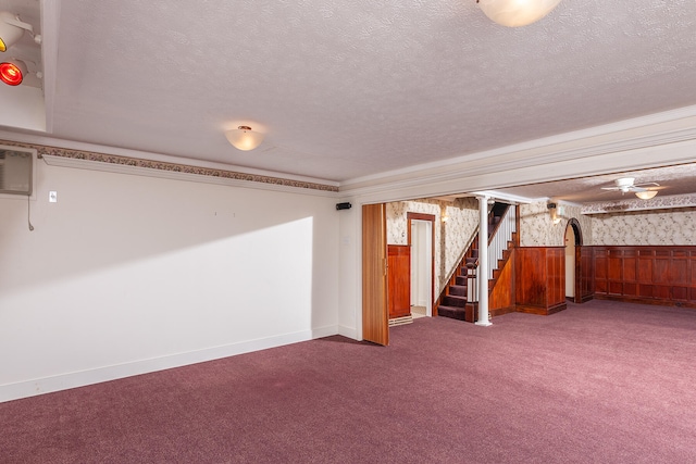 basement with a textured ceiling and dark carpet