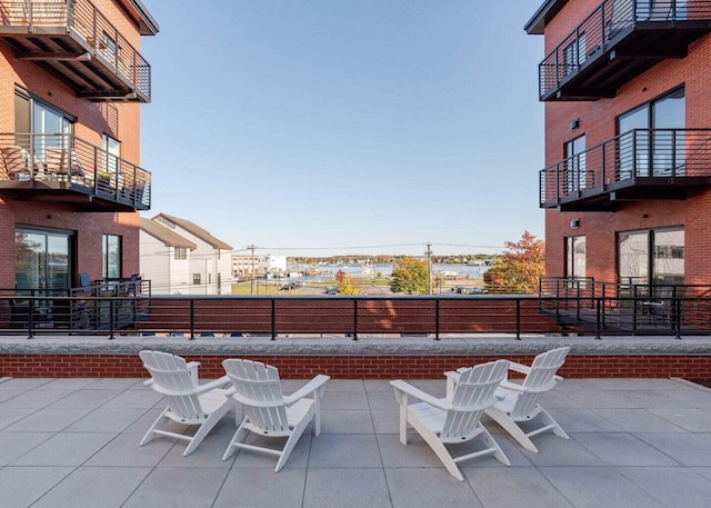 view of patio / terrace with fence and a balcony