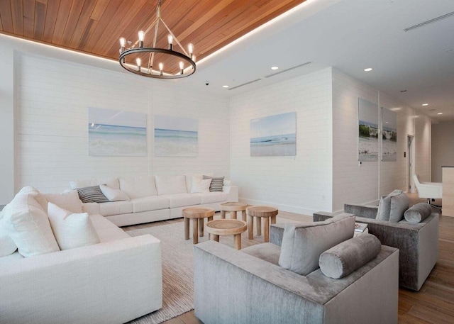 living area with visible vents, an inviting chandelier, recessed lighting, wood finished floors, and wood ceiling