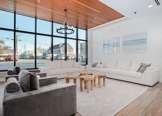 living area featuring light wood-style flooring, an inviting chandelier, recessed lighting, floor to ceiling windows, and wood ceiling