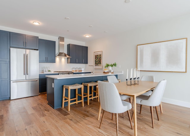 dining space featuring light wood-style floors and baseboards