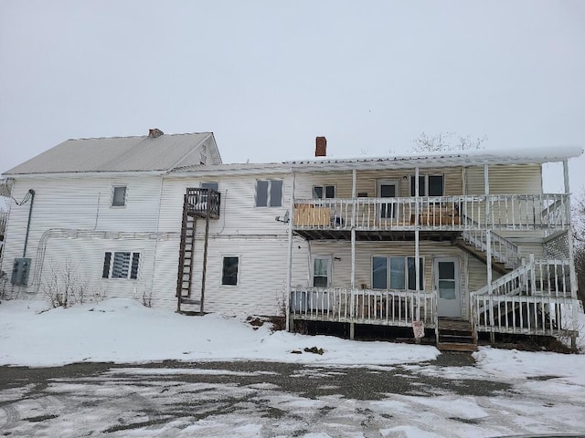 snow covered property with a balcony