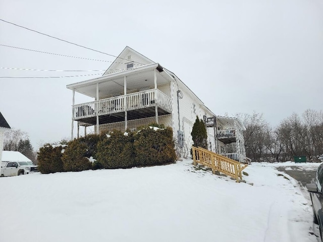 view of snow covered rear of property