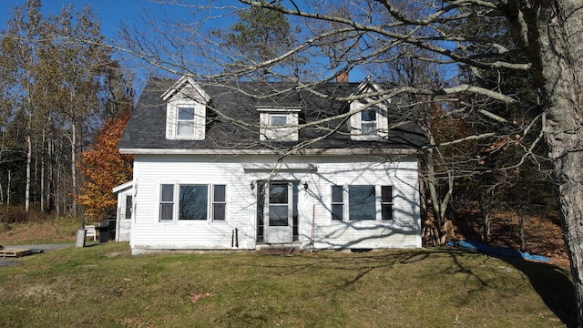 cape cod-style house with a front yard