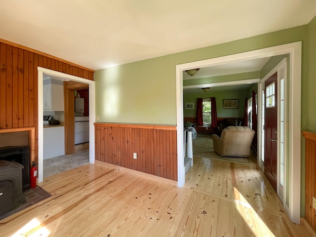 spare room with wood walls and light hardwood / wood-style flooring