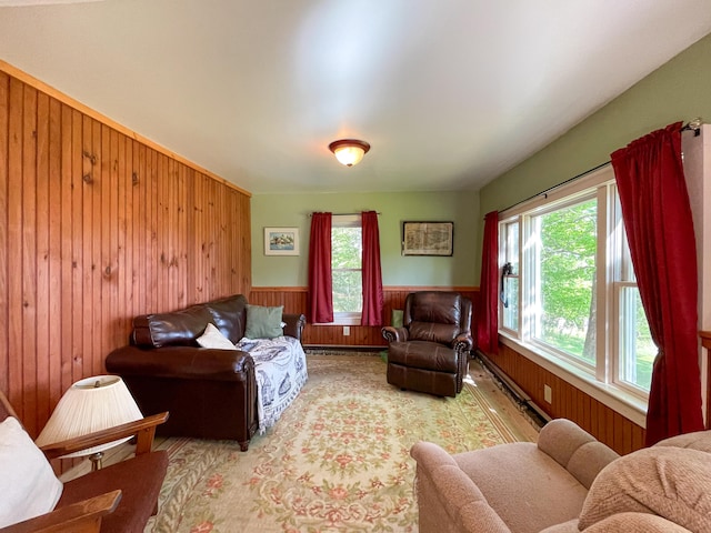 living room featuring light hardwood / wood-style flooring, a healthy amount of sunlight, and wooden walls