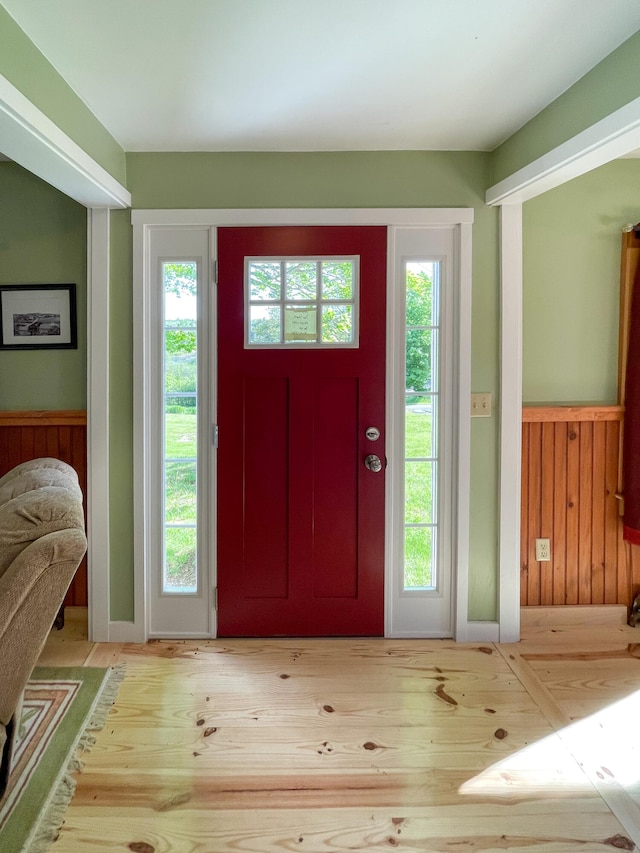 foyer entrance with light hardwood / wood-style flooring and a wealth of natural light