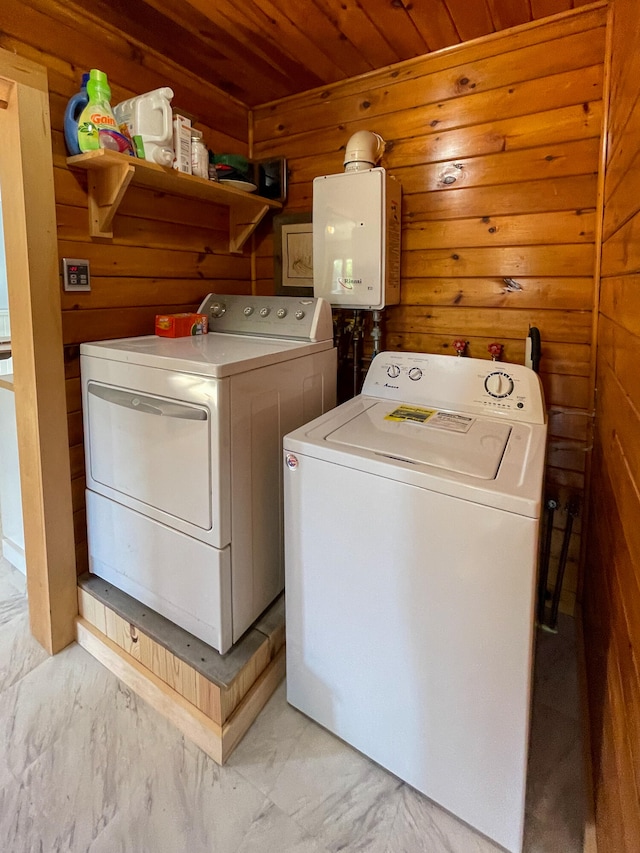 clothes washing area with wood walls, wood ceiling, and washing machine and dryer