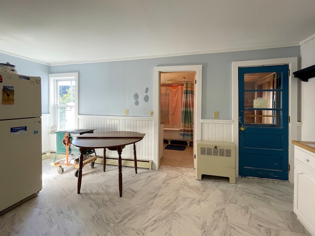 tiled dining area with radiator heating unit and crown molding