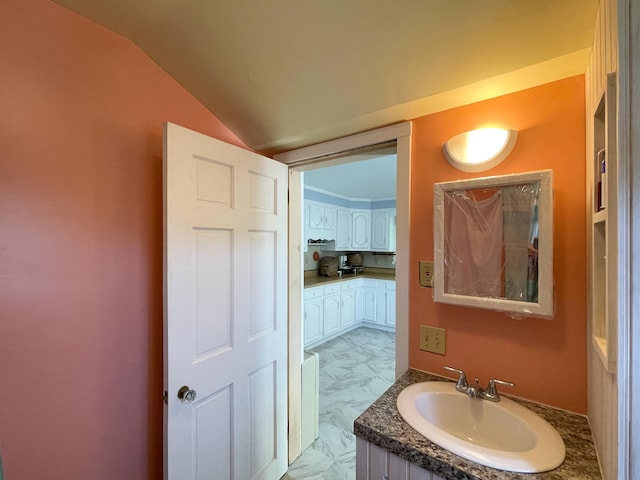 bathroom featuring lofted ceiling, vanity with extensive cabinet space, and tile flooring