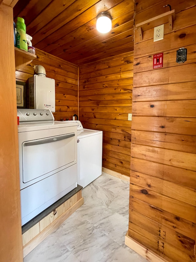 clothes washing area featuring washer and clothes dryer, wooden walls, wooden ceiling, and light tile floors