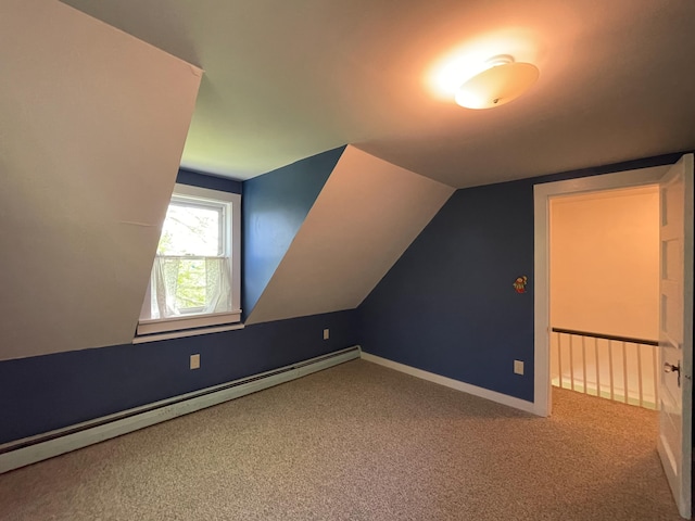 additional living space featuring light carpet, a baseboard heating unit, and lofted ceiling