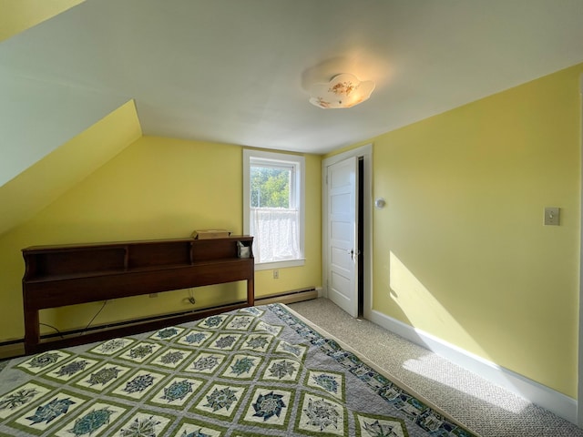 bedroom featuring baseboard heating, vaulted ceiling, and light colored carpet