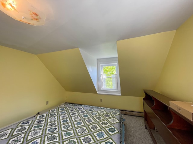 bedroom featuring lofted ceiling, carpet, and a baseboard heating unit