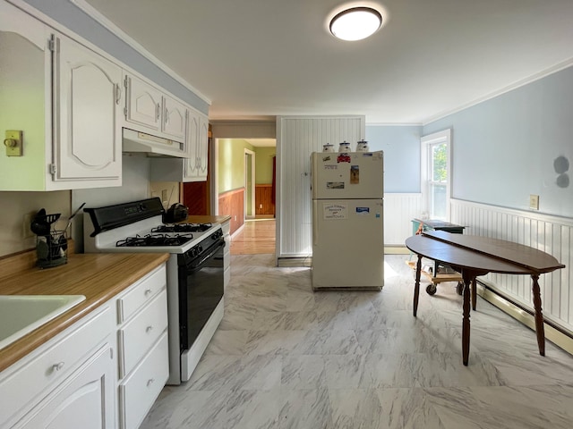 kitchen with crown molding, white appliances, light tile floors, and white cabinets