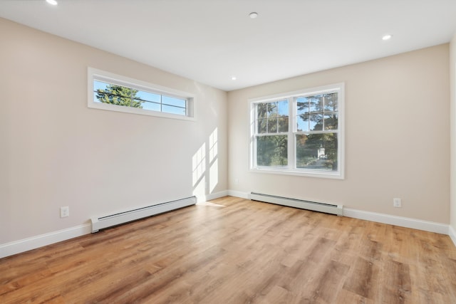 spare room featuring baseboards, recessed lighting, light wood-style flooring, and a baseboard heating unit